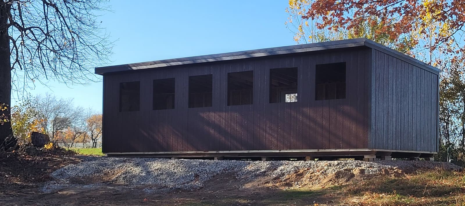 Exterior of the heated 5-stand shooting shelter in fall