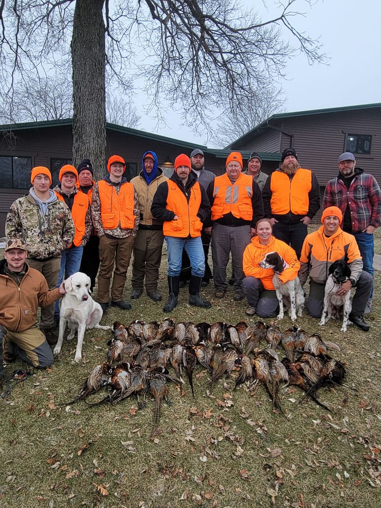 Large hunting group with harvested birds at the lodge