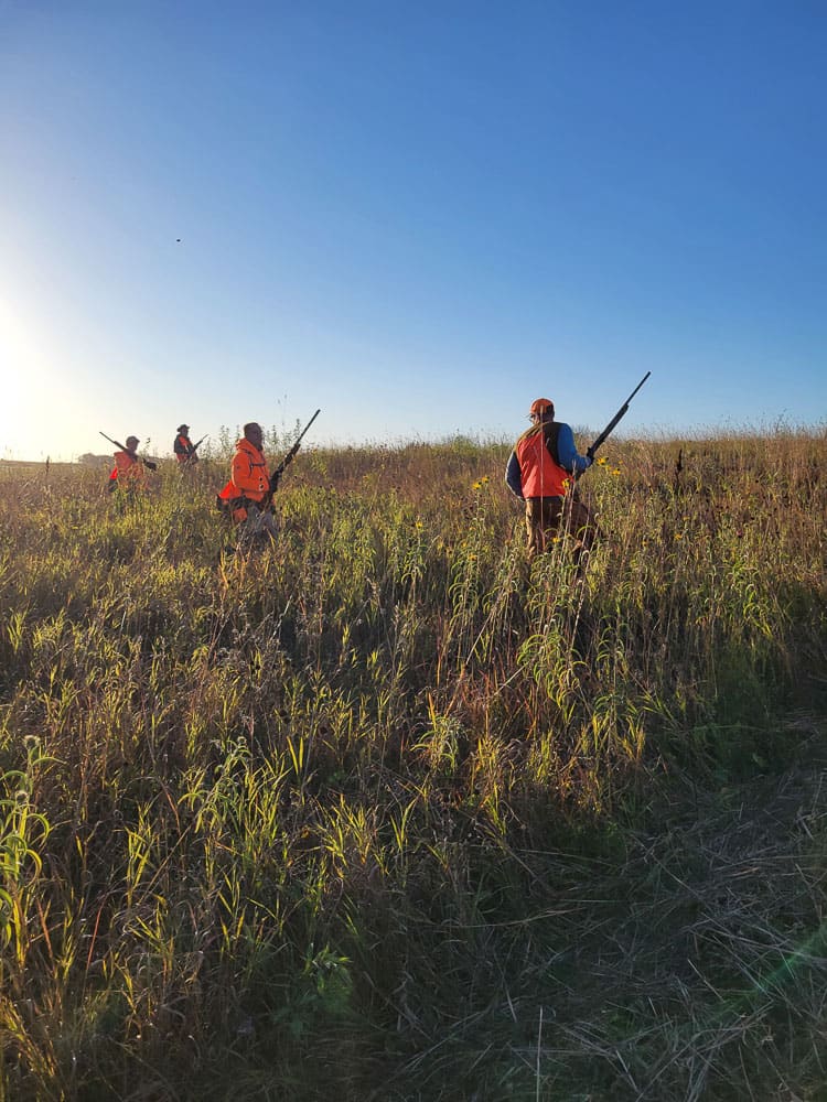 Hunters walking through a field on a starter hunt